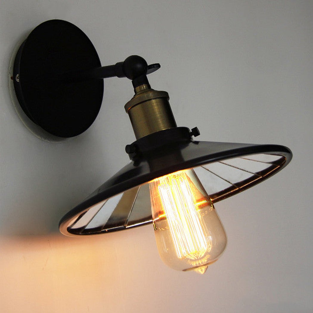 Vintage industrial look wall sconce light with black lamp shade with mirror inside.