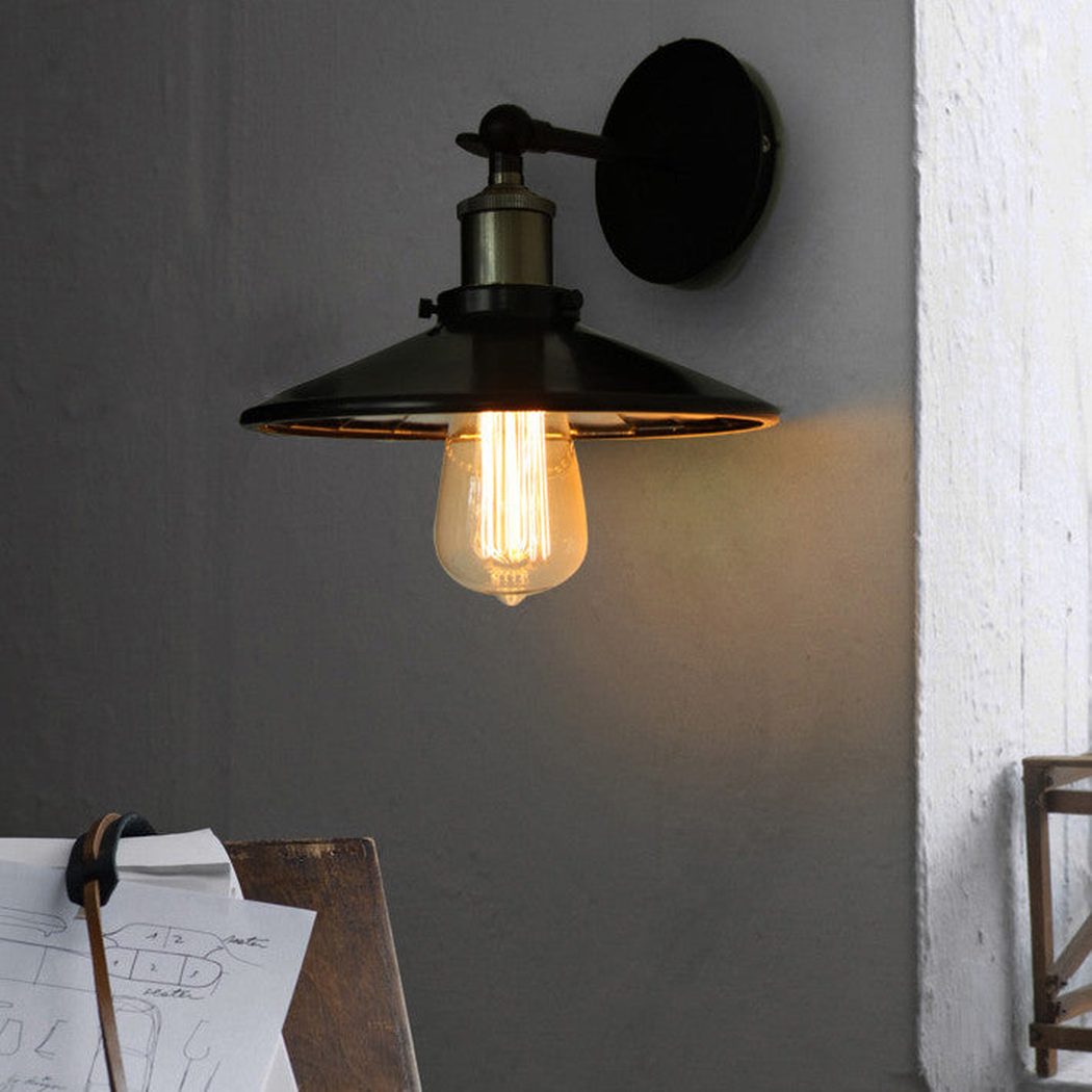 Vintage industrial look wall sconce light with black lamp shade with mirror inside.