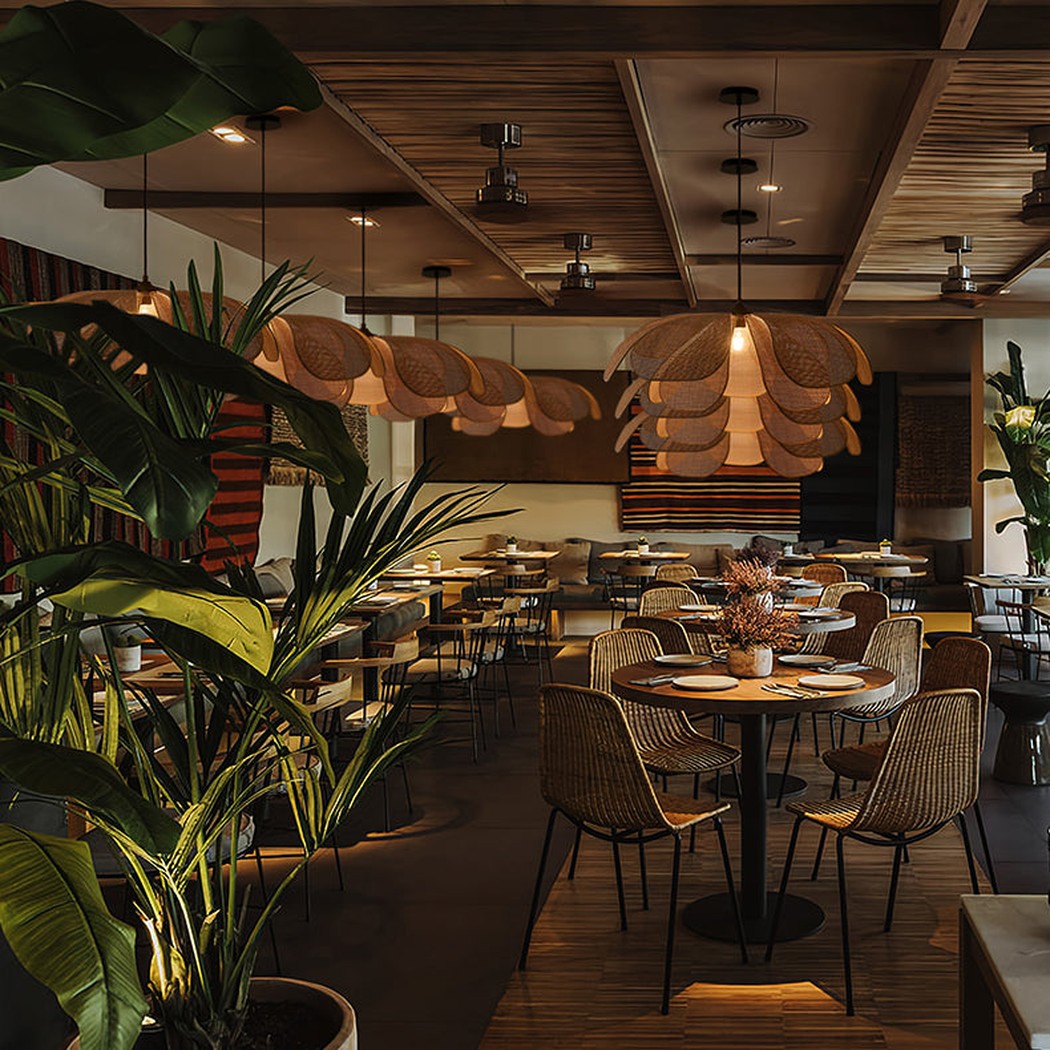 Cefalu Rattan Petals Floral Pendant Light installed in a bohemian styled restaurant with botanicals