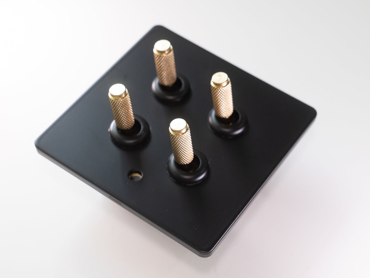Paddington Knurled 4 gang quad flip light switch - in black and brass