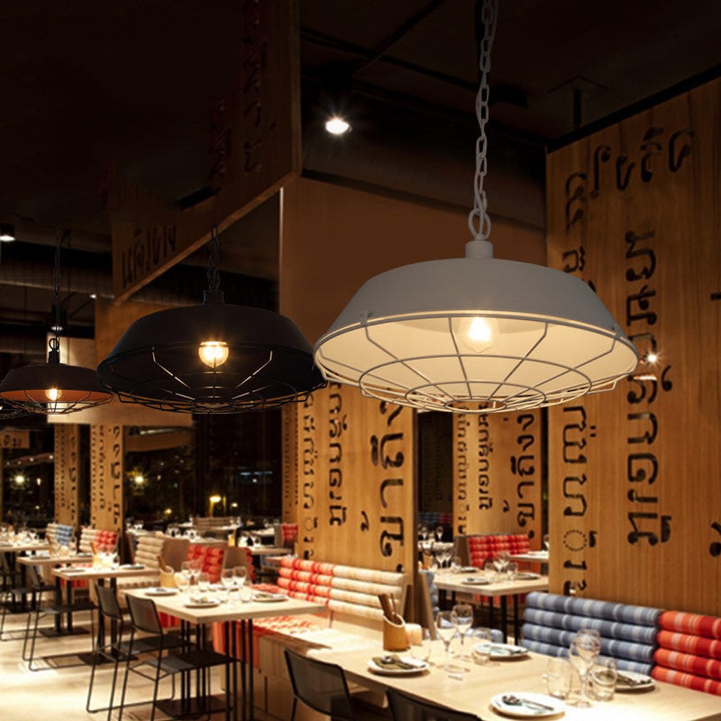Vintage Industrial Pendant Light With Cage Covering restaurant setting