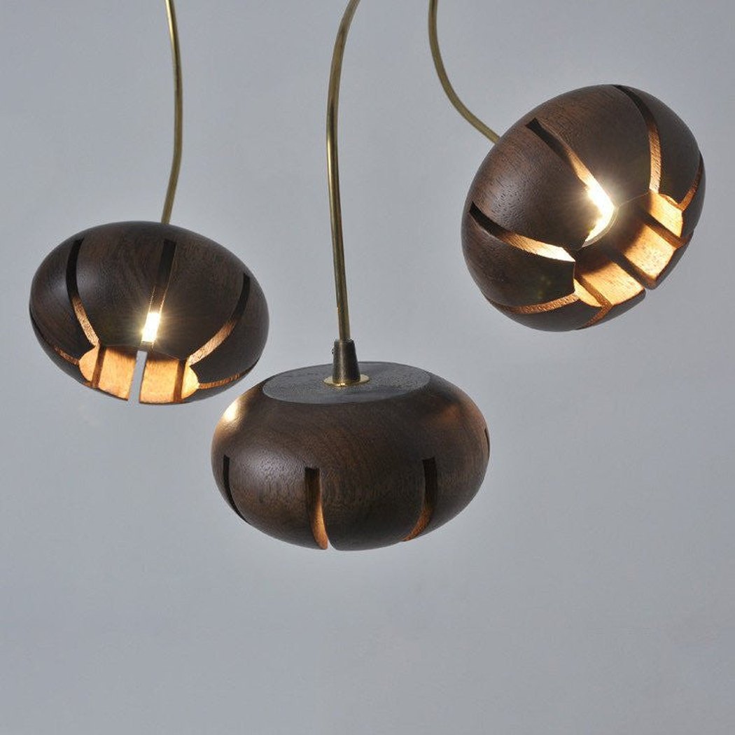 Wooden flower petal strip on copper wire pendant light close up dark wood