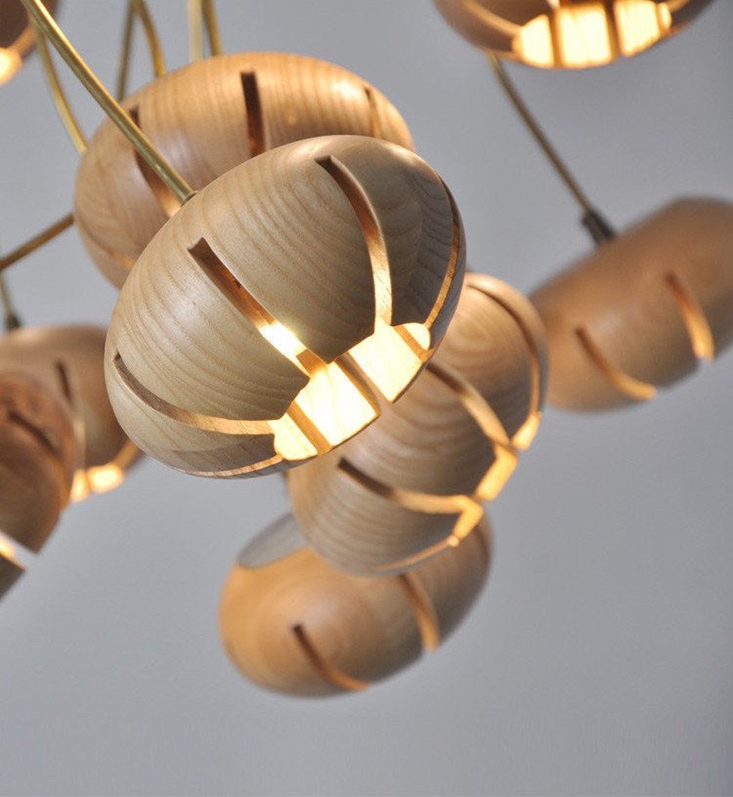 Wooden flower petal strip on copper wire pendant light close up light wood
