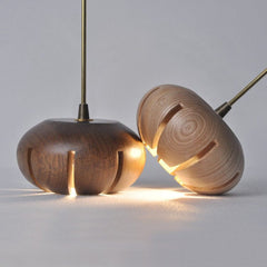 Wooden flower petal strip on copper wire pendant light light wood close up